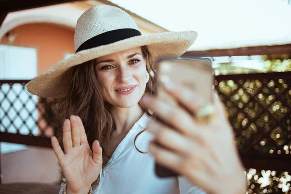 Smiling Young Female White Shirt Hat Having Video Meeting Smartphone — Stock fotografie