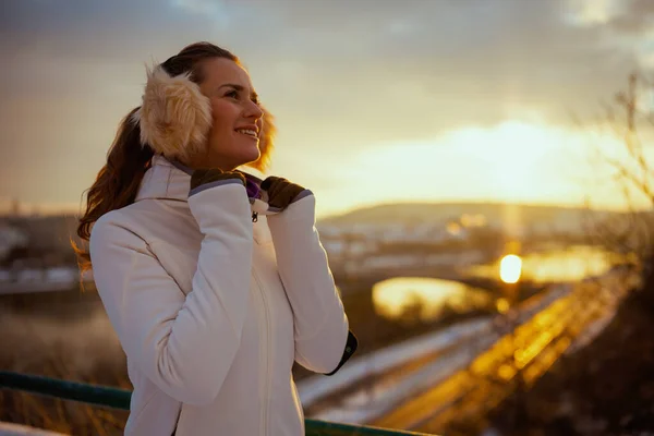 Happy Young Woman White Jacket Ear Warmer City Winter Sunset — Foto Stock