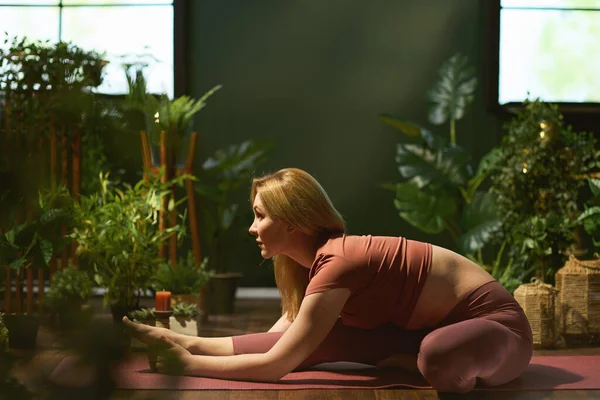 modern woman in the modern green living room stretching.