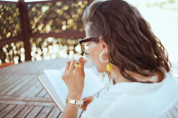 Seen Middle Aged Woman White Shirt Eyeglasses Sitting Table Drinking — Foto Stock