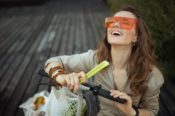 Happy Stylish Female Sunglasses Overall String Bag Scooter Celery Sitting — Stok fotoğraf