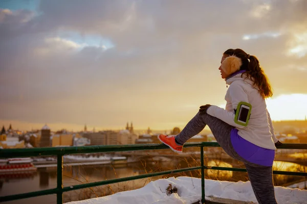 Healthy Woman White Jacket Ear Warmer Stretching City Winter Sunset — Stock Photo, Image