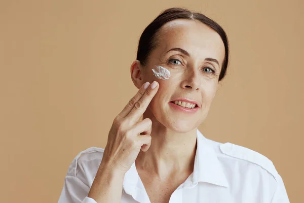 Happy Modern Woman Facial Cream Face White Shirt Isolated Beige — Stock Photo, Image