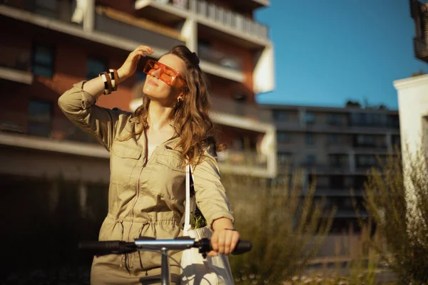 Smiling Modern Middle Aged Woman Sunglasses Overall Tote Bag Scooter Stock Photo