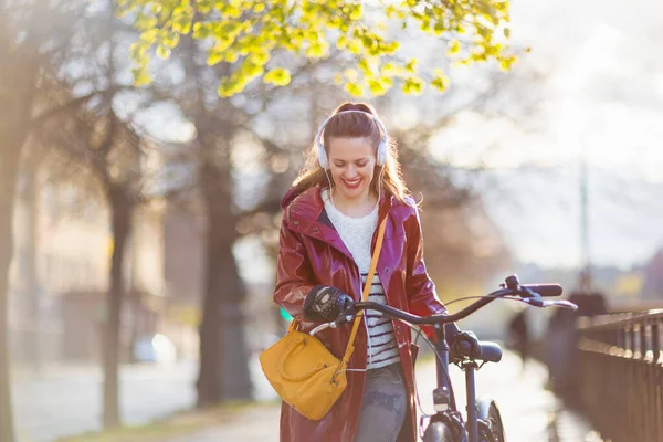 Smiling Stylish Years Old Woman Red Rain Coat Bicycle Listening — Fotografia de Stock