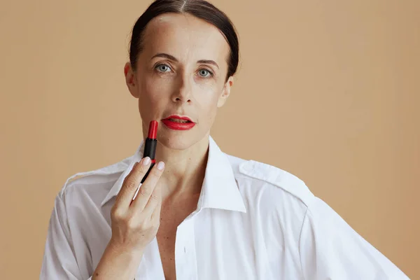 Modern Middle Aged Woman Red Lipstick White Shirt Beige Background — Stockfoto