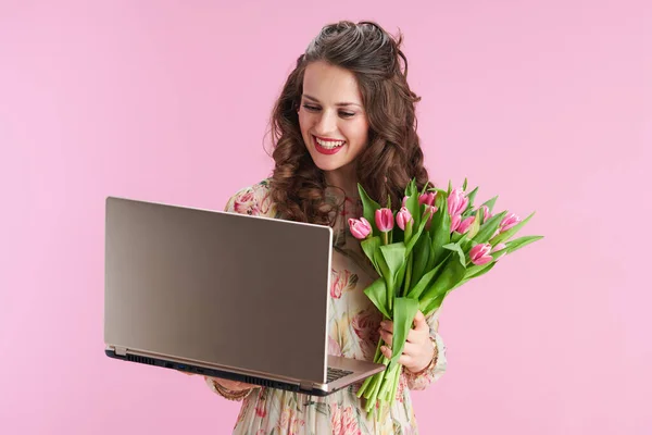 Smiling Young Woman Floral Dress Tulips Bouquet Using Laptop Isolated — ストック写真