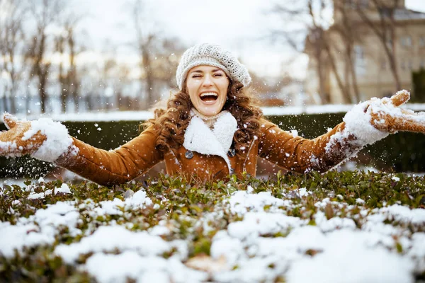 Smiling Elegant Female Mittens Knitted Hat Sheepskin Coat Throwing Snow — Stock fotografie