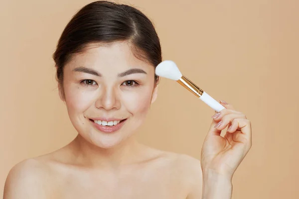 Modern Asian Woman Makeup Brush Beige Background — Foto de Stock