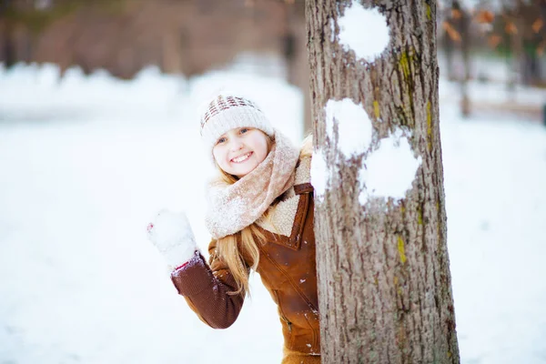 Smiling Stylish Girl Mittens Knitted Hat Sheepskin Coat Playing Snowball — 스톡 사진