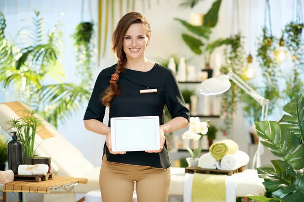 Happy Woman Worker Modern Beauty Studio Showing Tablet Blank Screen — Zdjęcie stockowe