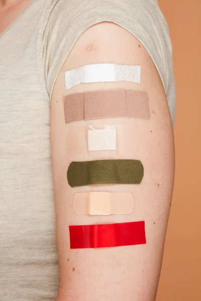 Closeup Middle Aged Woman Patches Hand Symbolizing Many Vaccines Done — Stockfoto