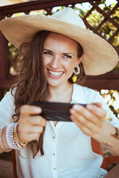 Happy Stylish Woman White Shirt Hat Sending Text Message Using — Stockfoto