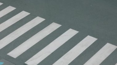 Beyaz kazaklı, sırt çantalı, yaya geçidinden geçen ve şehir dışındaki okula giden modern bir kızın üst görüntüsü..