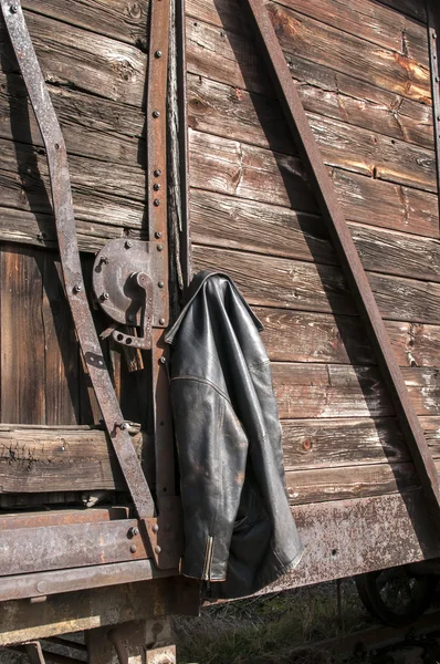 Leather jacket on wooden wall — Stock Photo, Image