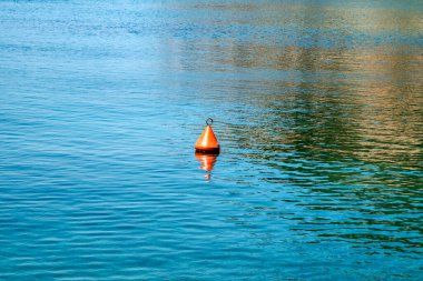 Buoy in calm blue sea waters closeup in sunny summer day