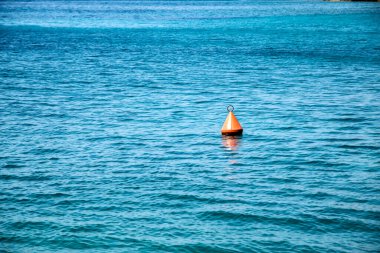 Buoy in calm blue sea waters closeup in sunny summer day