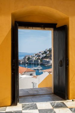 View of small Mediterranean town through the gate of old house court