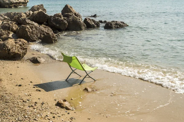 Folding chair on sea beach closeup in sunny summer day