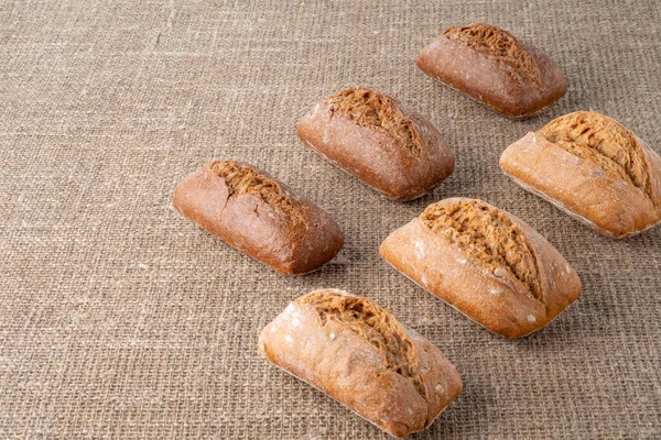 Bread, traditional sourdough bread, on a background of burlap. The concept of traditional ways of baking yeast bread. Healthy eating.