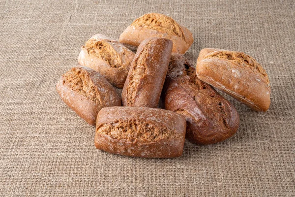 Bread, traditional sourdough bread, on a background of burlap. The concept of traditional ways of baking yeast bread. Healthy eating.