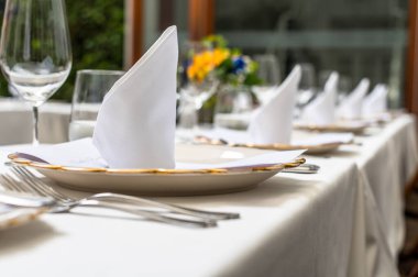 Elegant wedding lunch table decorated with crystal goblets and yellow flowers.