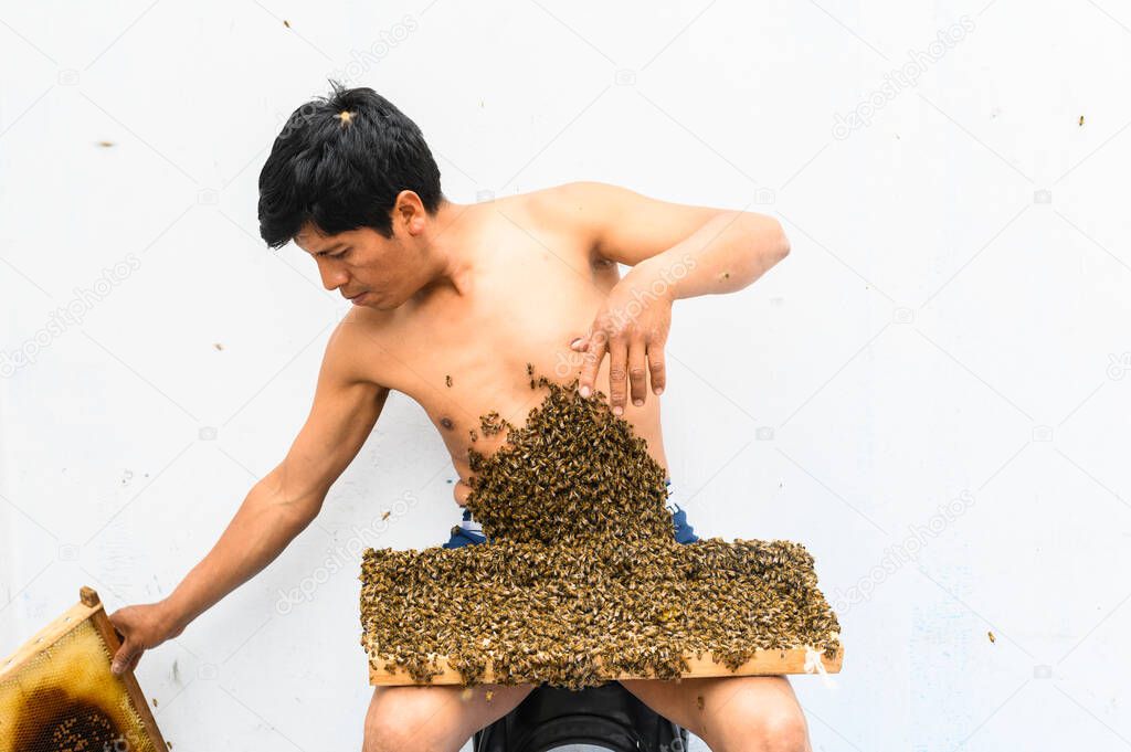 Man covered by many bees