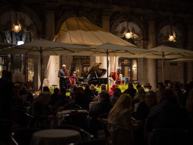 Venedik, İtalya - 31 Ekim 2021: Geceleri San Marco 'da bir kafede çalan müzisyenler