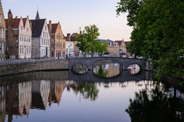Brugge, Belgium - July 4, 2022: Bridge over Langerei on a sunny day in summer