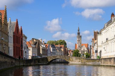 Brugge, Belgium - July 4, 2022: Bridge over Langerei on a sunny day in summer