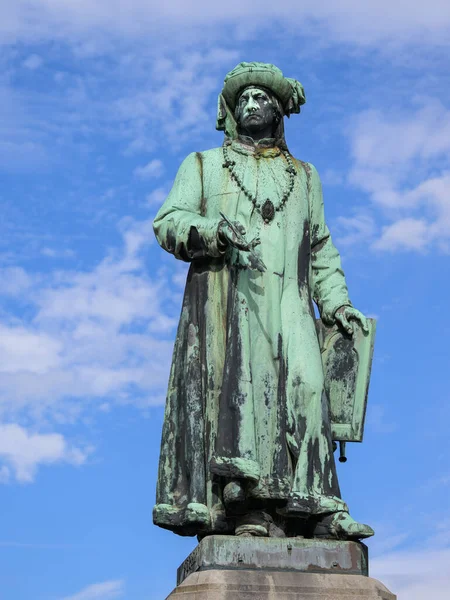 Statue of the famous painter Jan Van Eyck in Bruges, sunny day in summer