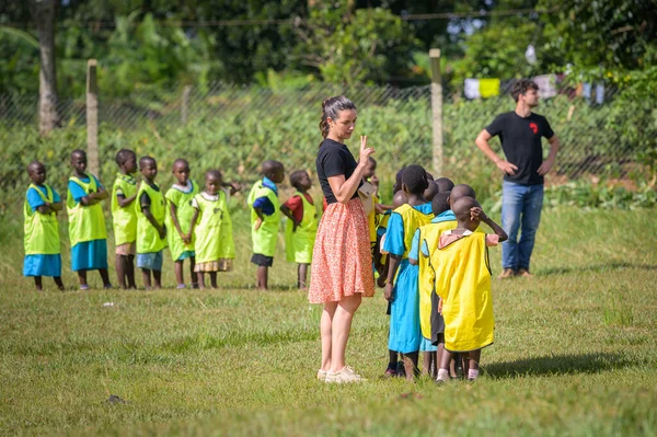 乌干达卡兰加拉 2022年5月19日 在多云的天气里 孩子们和来自欧洲的人在草地上玩耍 — 图库照片