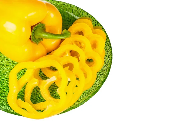 Ripe yellow pepper on green plate — Stock Photo, Image