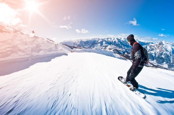 Snowboarder riding fast, motion blur, fisheye shot — Stock Photo, Image