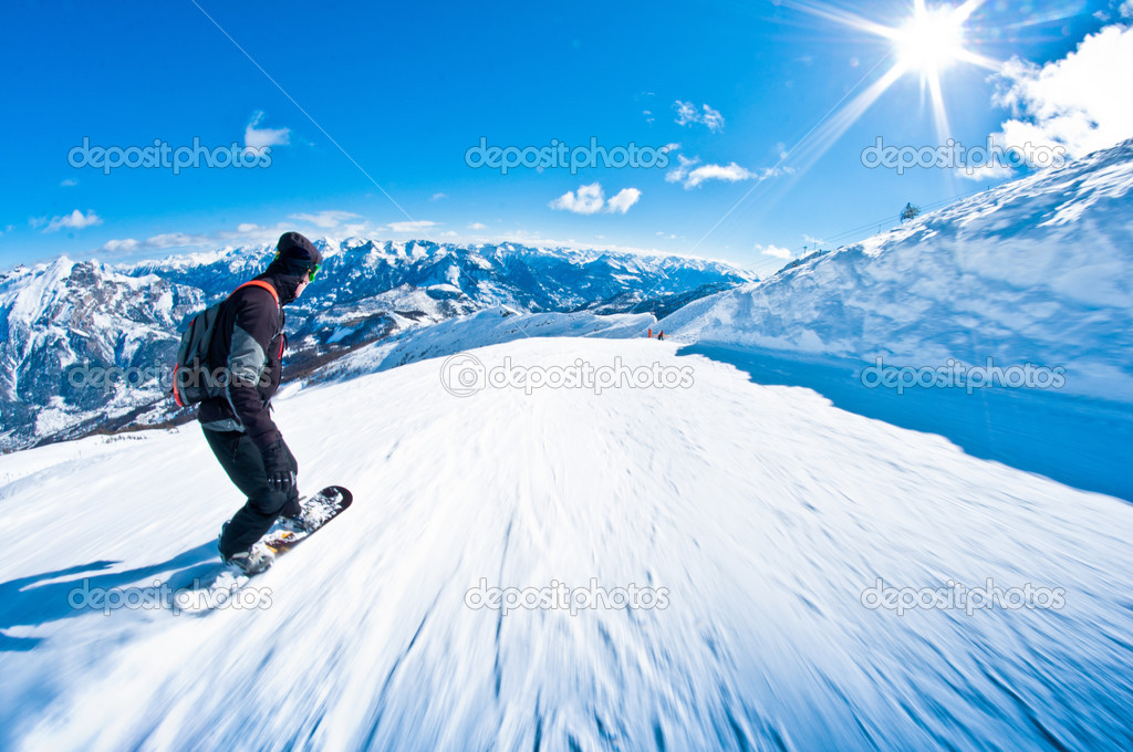 Snowboarder riding fast, motion blur, fisheye shot