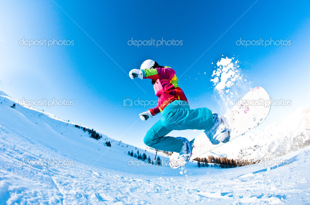 Girl snowboarder having great fun jumping