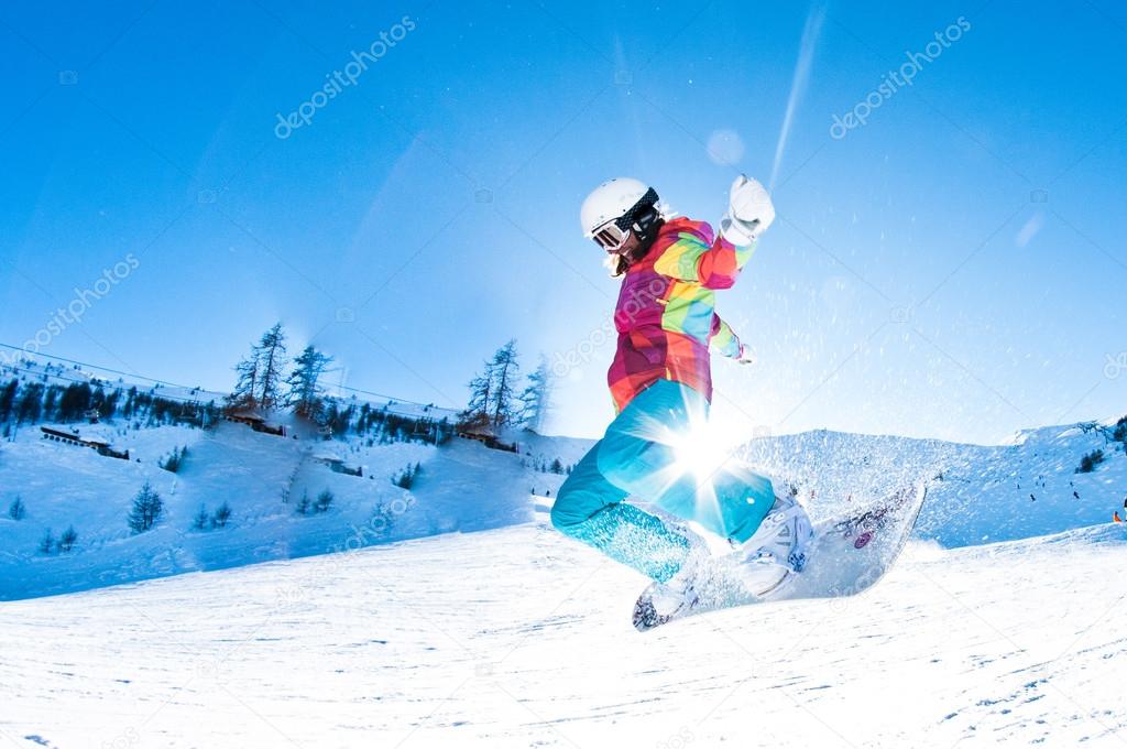 Girl snowboarder having great fun jumping