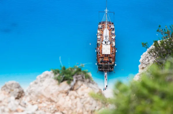 Large sail cruise ship anchored at white sand beach, seen from above — Stock Photo, Image