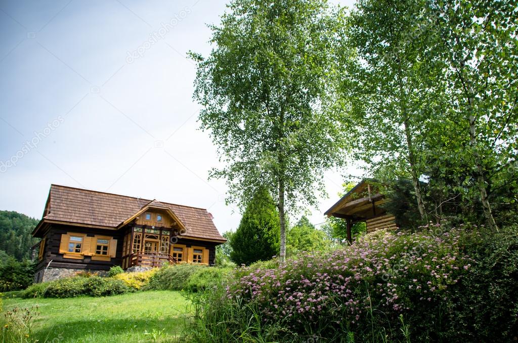 Romantic rustic wooden cottage in rural area