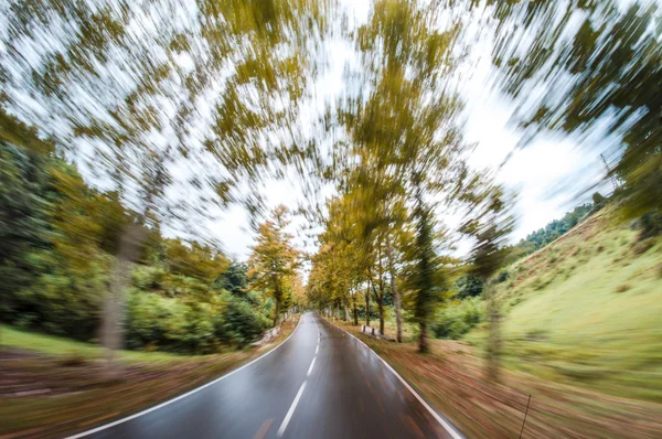 Driving fast, motion blurred image of a road — Stock Photo, Image