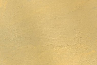 Arka plan olarak kullanılmak üzere sarıya boyanmış eski bir beton duvarın fotoğrafı