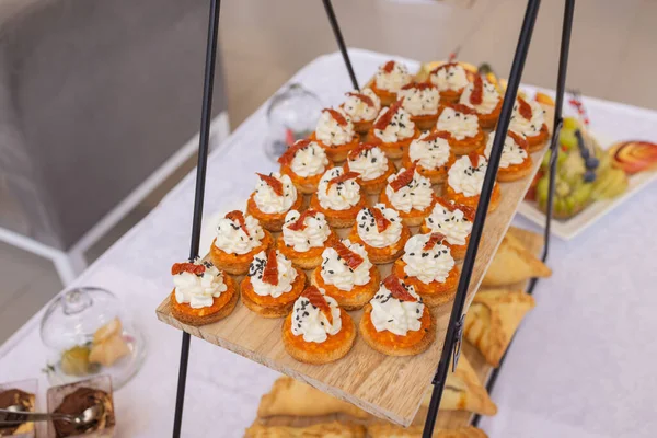Different types of canapes on buffet table. — Stock Photo, Image