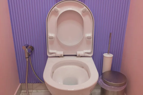 Modern ceramic toilet bowl near color wall in restroom. — Stock Photo, Image