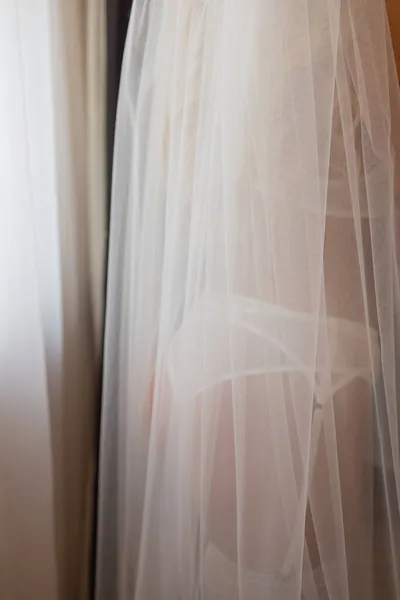 Oigenkännlig bruden i en siden morgonrock med vackra smala ben är att sätta på strumpor. Bröllop morgon beredning. Dressing Underkläder, boudoir. — Stockfoto