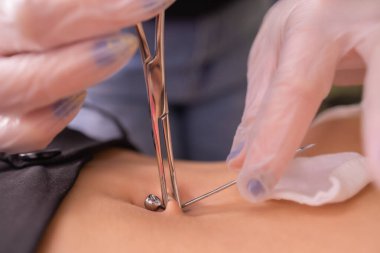 İlk piercing. Küpe göbek üzerinde giyinme. Piercing erkek.