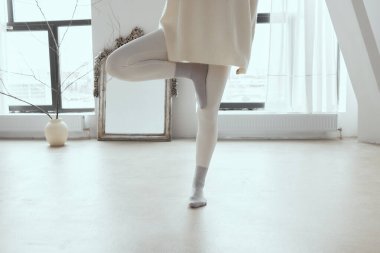 Geniş bir stüdyoda yoga yapan kadın..