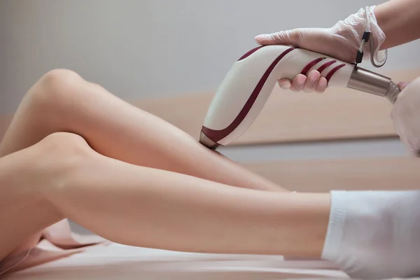 Young woman getting laser hair removal on her thighs. — Stock Fotó