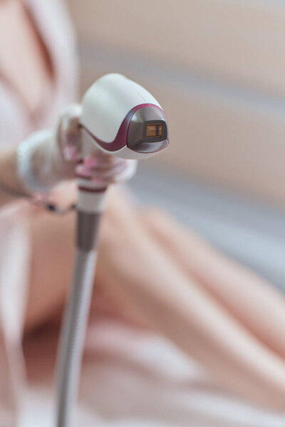 Young woman getting laser hair removal on her thighs.