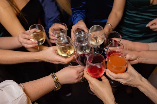 Celebrating with glasses of alcohol in hands. Happy female friends having good time. — Stock Photo, Image