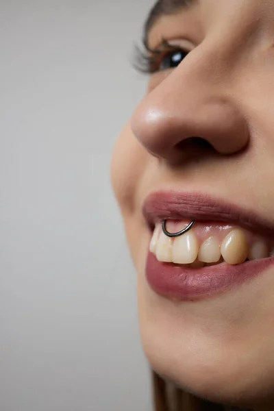 Smile or frenulum piercing under the upper lip. — Stock Photo, Image